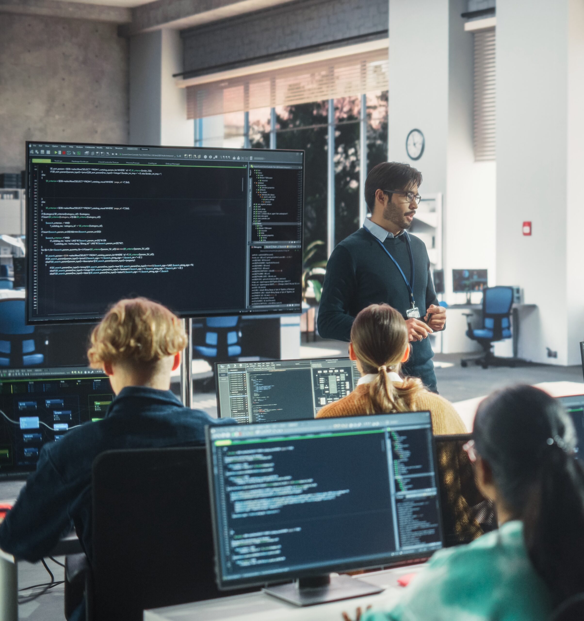 Teacher Giving Lesson to Diverse Multiethnic Group of Female and Male Students in College Room. Class Learning About Computer Science and Software Development. Lecturer Shares Knowledge with Scholars